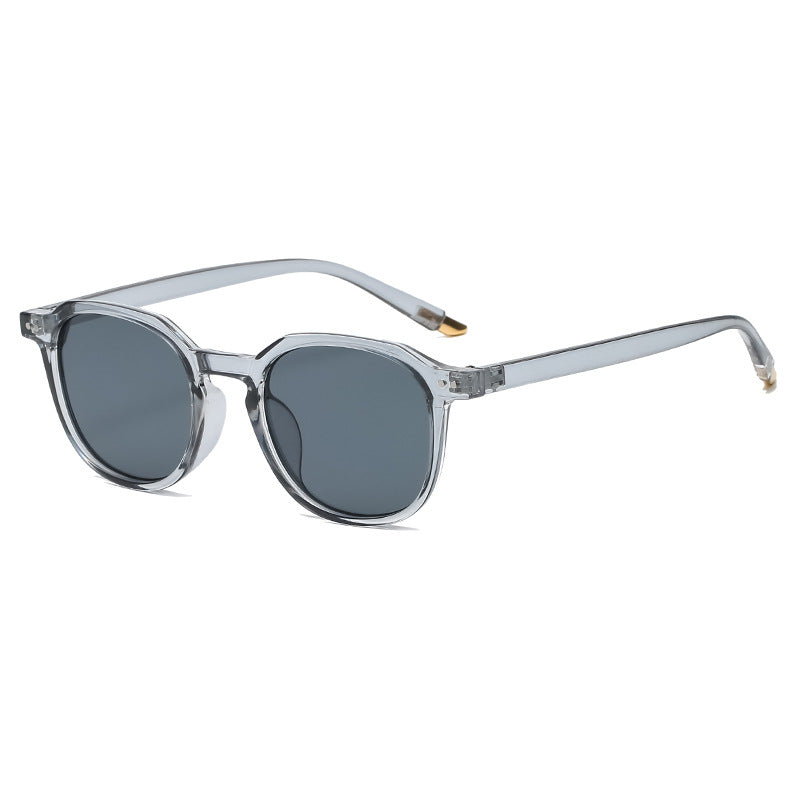 Gafas de sol redondas minimalistas gris translúcido con detalle dorado en patilla | Cientosiete
